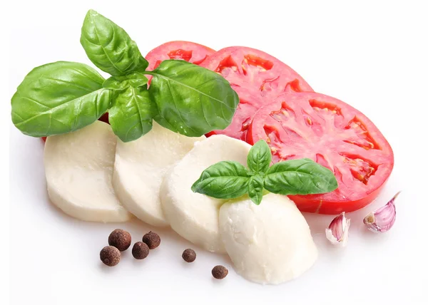 Ingredients for making salad with mozzarella and tomatoes on a w