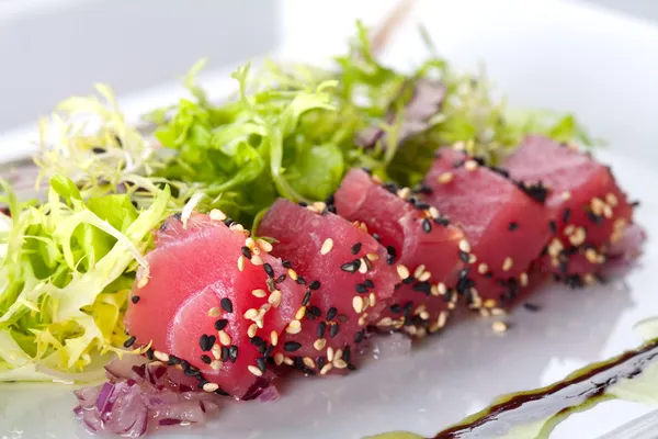 Raw fish tuna with salad frieze
