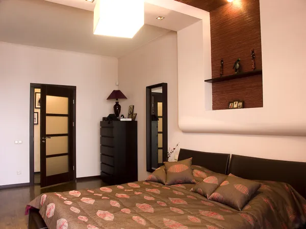 Bedroom with the big double bed with white bed. Design in East style