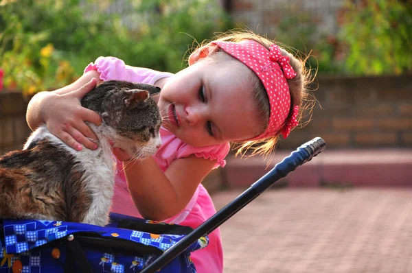 Girl playing with old cat