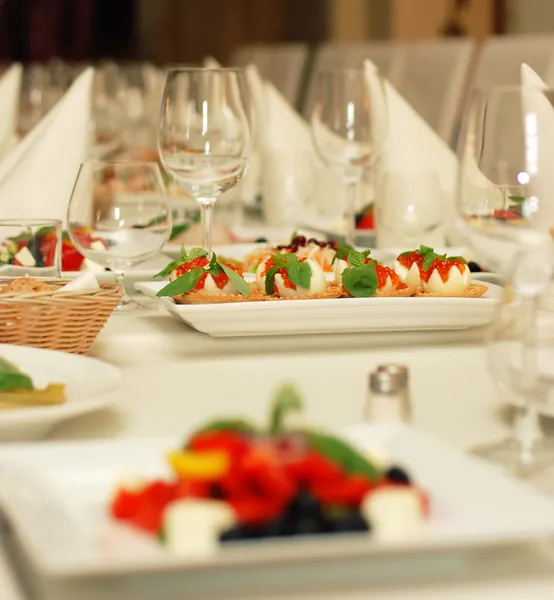 Table in restaurant with fine food and wine glasses