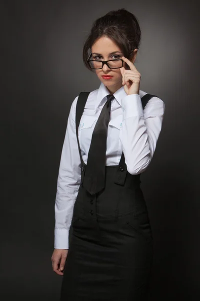 Confident attractive business woman in glasses looking at camera
