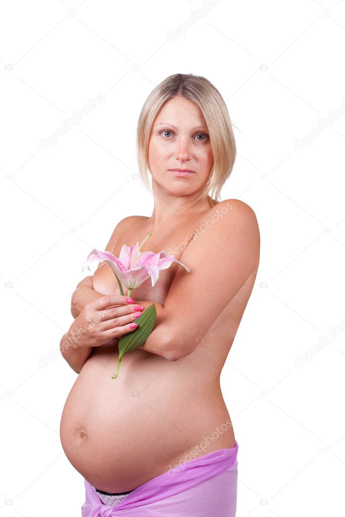 Pregnant happy blonde woman holding her belly and lily flower