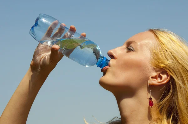 Girl drinking water from a plastic bottle — Stock Photo #3631098