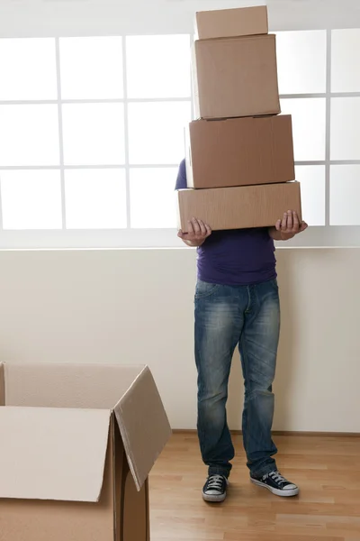 Man Carrying Stacked Boxes