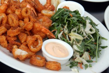 Fried Shrimps and calamary with salad clipart