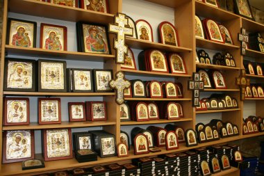 Christian icons and other symbols in souvenirs Shop in Jerusalem, Israel. clipart