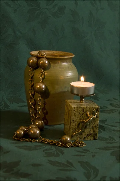 Retro Still Life with burning candle and ceramic jar — Stock Photo, Image