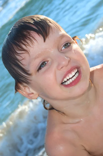 Happy boy in waves — Stock Photo, Image