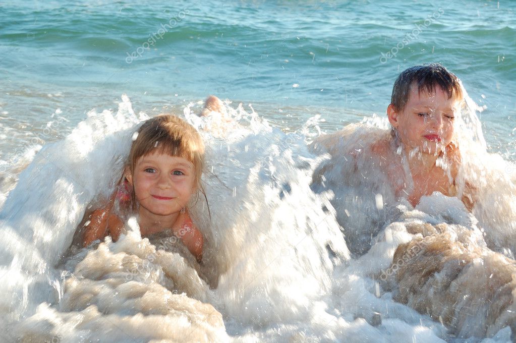 Children in waves on the beach