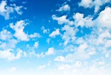 Brightly blue sky with sparce clouds clipart