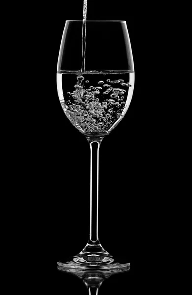 Pouring water in the wineglass — Stock Photo, Image