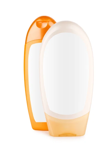Состав белого и оранжевого бутылок — стоковое фото