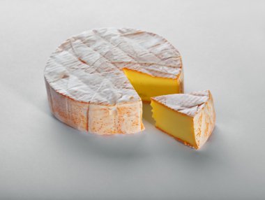 Cheese with a white mould on gray background clipart