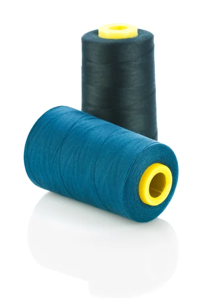 Blue and black threads on spools — Stock Photo, Image