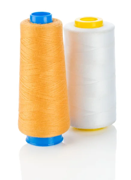 Orange and white thread on spools isolated — стоковое фото