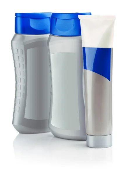 Sammansättning av grå flaskor schampo och röret — Stockfoto