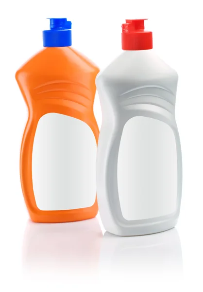 Оранжевые и белые бутылки для чистки — стоковое фото