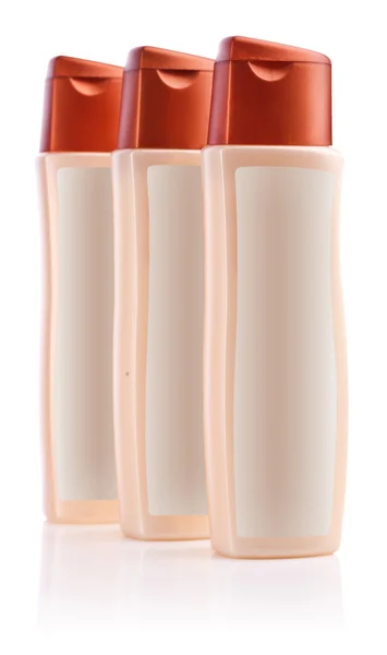 Tre bottiglie marroni di shampoo — Foto Stock