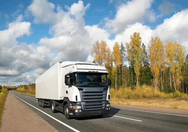 White truck on autumn country highway — Stock Photo, Image