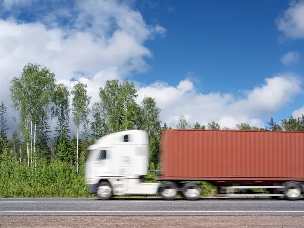 Witte vrachtwagen versnellen op landelijke snelweg, motion blur — Stockfoto