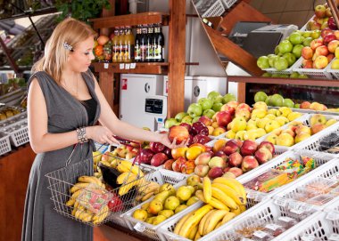 Woman grocery shopping in supermarket clipart