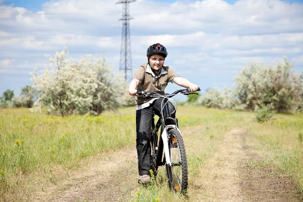 stock image Boy riding bike in a helmet