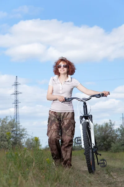 stock image Woman riding bike in countryside