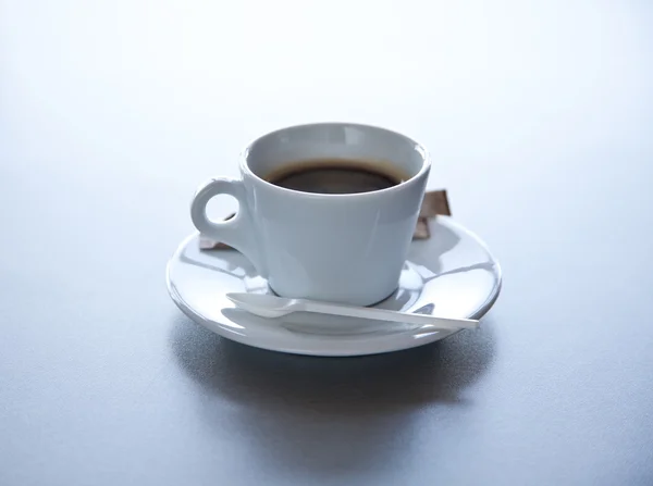 Cup of coffe on grey steel table — Stock Photo, Image