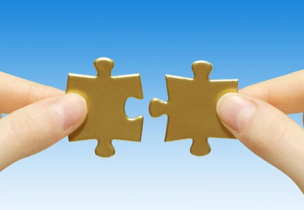 Puzzle in hands — Stock Photo, Image