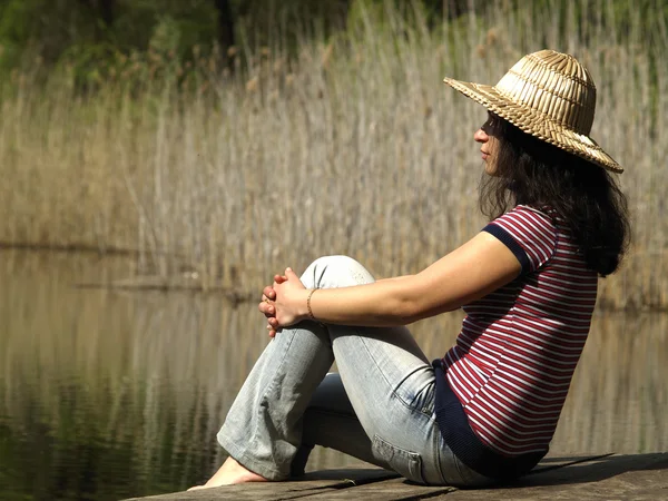 Göl kenarında oturan kız — Stok fotoğraf