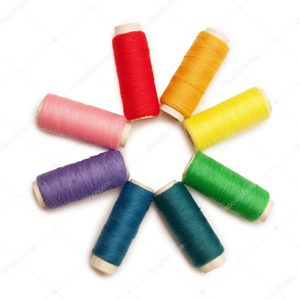 Rainbow colored set of threads over white background