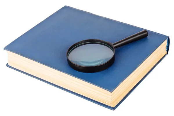 Vergrootglas op een blauwe boek — Stockfoto