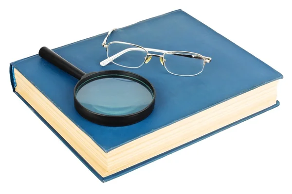 Bril op een blauwe boek — Stockfoto