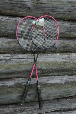 Badminton Rackets and Birdie on the Wooden Wall clipart