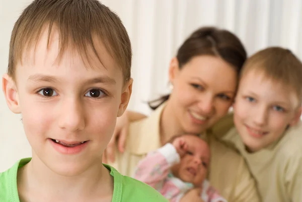 Boy with mother and brothers — Stock Photo, Image