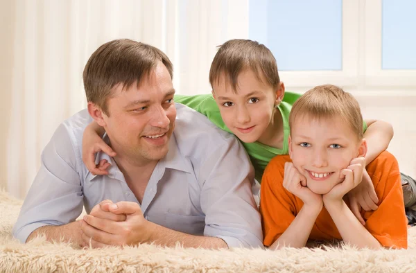 Father lying with two sons — Stock Photo, Image