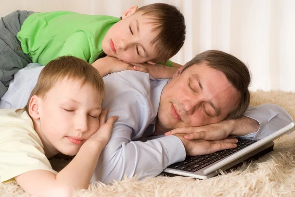Apa alszik fiai egy laptop — Stock Fotó