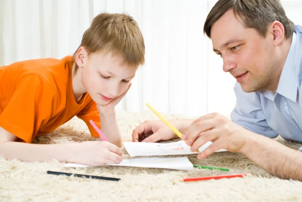 Father and son lying and draw — Stock Photo, Image