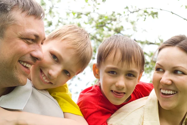 Happy boys with family in the summer park — Stock Photo, Image