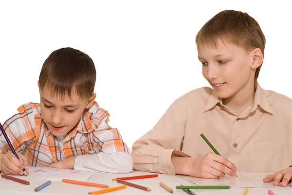 Brothers sit at the table and draw Stock Photo