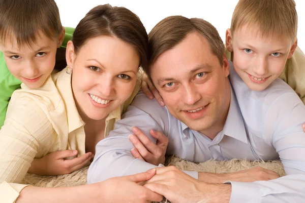 Family lying on the carpet Royalty Free Stock Images