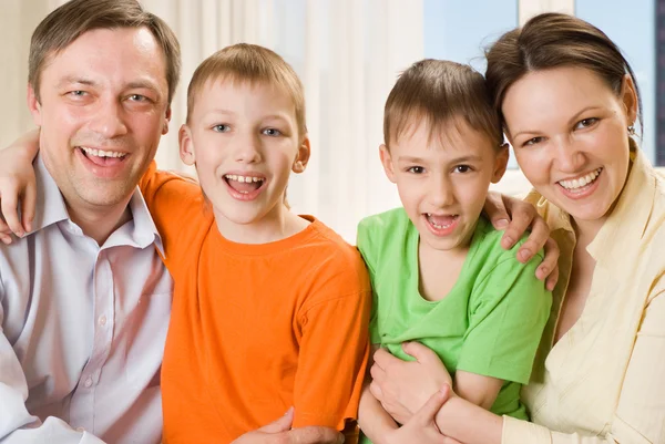Parents are on the carpet with sons Stock Photo