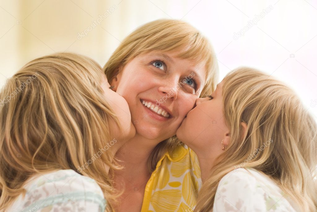 Daughters kissing his mom