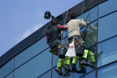 Washing windows on the height clipart