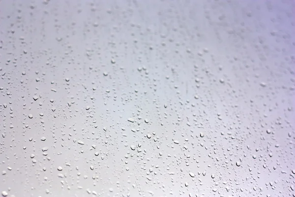 stock image Drops of rain on the inclined window (glass)