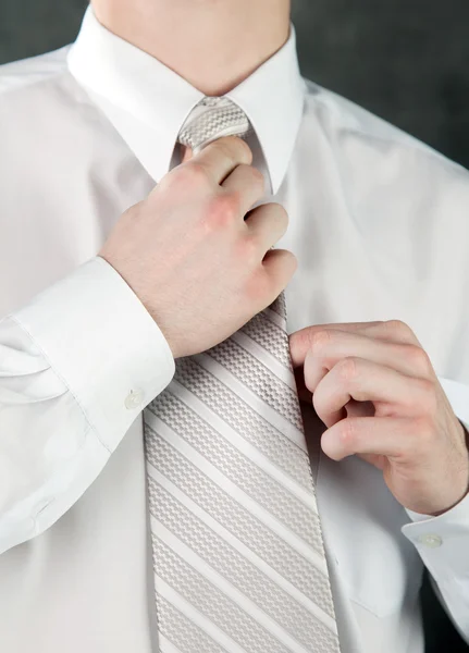 stock image Businessman is adjusting his tie