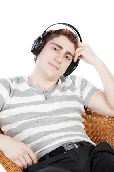 Young man is relaxing on armchair — Stock Photo, Image