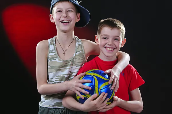 stock image Two laughing boys with a ball