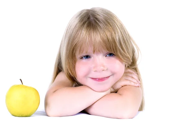 Little girl with yellow apple — Stock Photo, Image